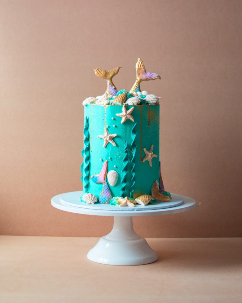 Kid's birthday cake with ocean theme and mermaids