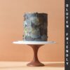 Grey shade pastel coloured cake on top of a cake stand