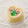 Heart-shaped cake decorated with buttercream tulips and lavender flowers for Mother’s Day