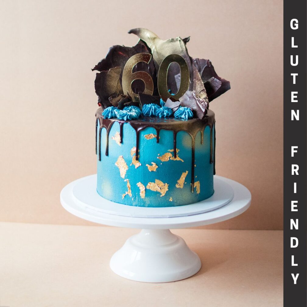 Blue themed caked with chocolate drip, chocolate shards on top