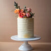 Vintage birthday cake with orange rustic flowers
