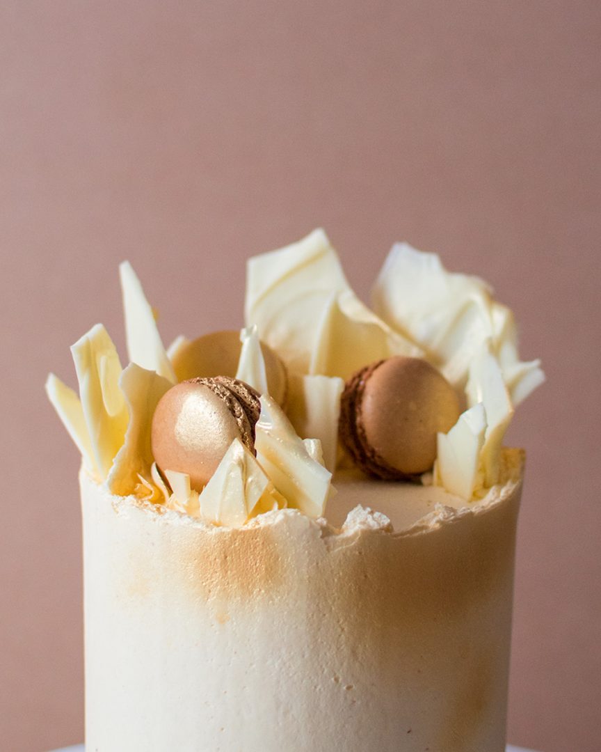 a close up image of a birthday cake with white chocolate shards on top